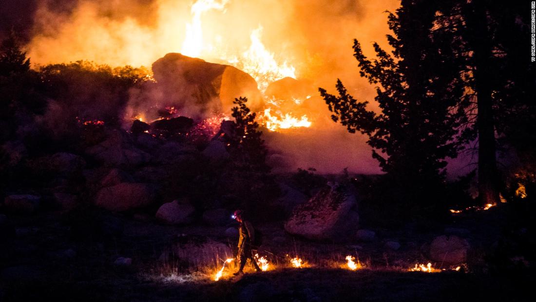 A firefighter is seen as the Caldor Fire rages near California&#39;s Silver Lake on September 2.