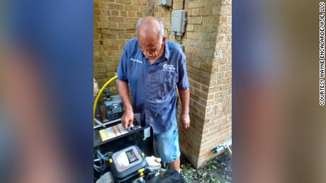 Wayne Encalarde installs a generator onto his home after Hurricane Ida to get his home based business up and running. 