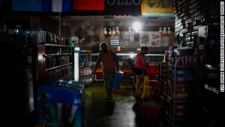 Shoppers buy supplies at a grocery store during the blackout after Hurricane Ida in New Orleans, Louisiana, on , Sept. 2, 2021. 