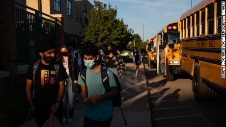 Students arrive at a high school during the first day of classes in Novi, Michigan, on September 7, 2021.