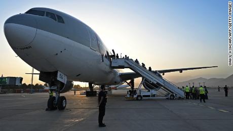 Passengers board a Qatar Airways aircraft at Kabul airport on September 9, 2021.