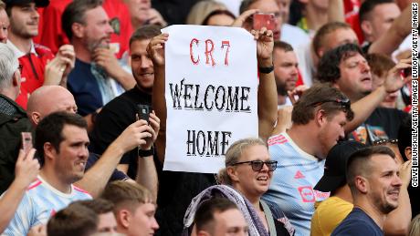 A fan holds aloft a &#39;CR7 Welcome Home&#39; sign up during the match between Manchester United and Newcastle.