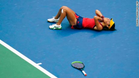 British player Emma Raducanu lies on the court after defeating Leylah Fernandez, of Canada, on September 11 in New York. 