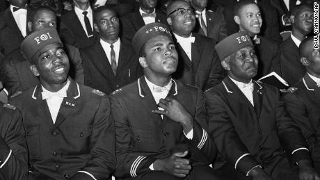 Ali, who joined the Nation of Islam in the early 1960s, listens to then-leader Elijah Muhammad as he speaks to other Black Muslims in Chicago in 1966.
