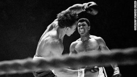 Three-time world heavyweight boxing champion Muhammad Ali is shown in the ring.