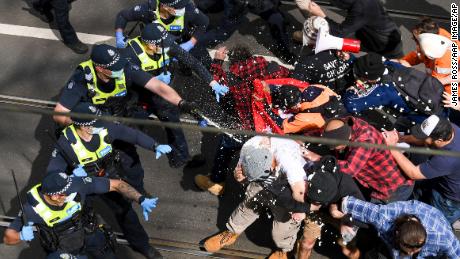 Victoria police fire pepper spray during a clash with protesters at a Rally for Freedom in Melbourne, Australia, on Saturday, Sept. 18, 2021. 