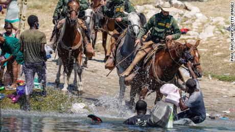 United States Border Patrol agents on horseback tries to stop Haitian migrants from entering an encampment on the banks of the Rio Grande near the Acuna Del Rio International Bridge in Del Rio, Texas on September 19, 2021. - The United States said Saturday it would ramp up deportation flights for thousands of migrants who flooded into the Texas border city of Del Rio, as authorities scramble to alleviate a burgeoning crisis for President Joe Biden&#39;s administration. (Photo by PAUL RATJE / AFP) (Photo by PAUL RATJE/AFP via Getty Images)