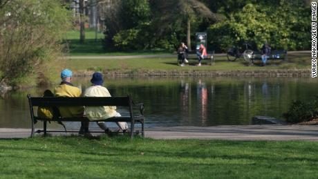 The ultimate niksen: A couple sits on a bench in front of a pond at Wilhelminapark in Utrecht, Netherlands.