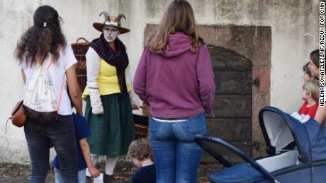 A storyteller dressed as a goat leads a tour of the Brothers Grimm House.
