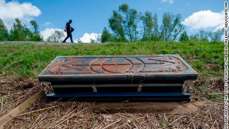 An overturned casket lays against Ironton&#39;s Mississippi River Levee on September 19.