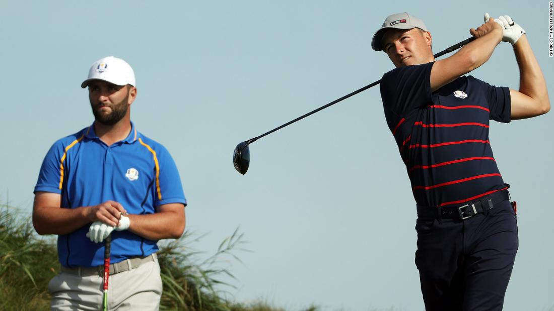 Spieth plays his shot from the 14th tee as Rahm looks on during Friday morning Foursome matches.