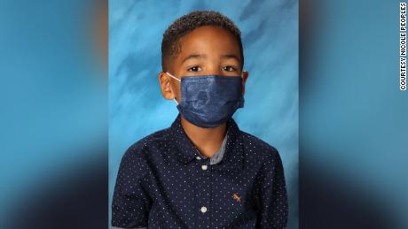 First grader wears mask for school picture because his mom told him not to take it off at school
