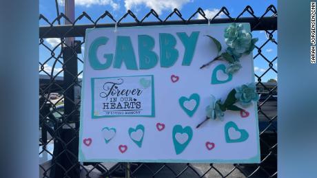A sign honor Gabby Petito hangs across the street from the Long Island funeral home where her family and members of the public gathered Sunday, September 26, 2021.
