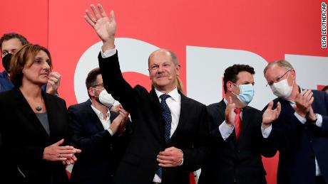 SPD&#39;s Olaf Scholz waves to his supporters after German parliament election at the party&#39;s headquarters in Berlin, on September 26.
