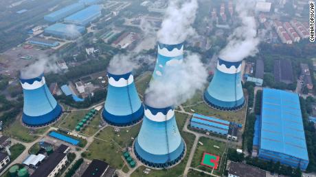 Steam billows out of the cooling towers at a coal-fired power station in Nanjing, China.