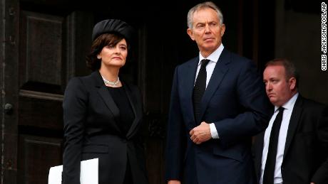 Former British Prime Minister Tony Blair and his wife Cherie Blair leave a funeral on April 17, 2013. 