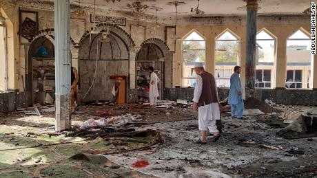 People inspect the inside of a mosque following a bombing in Kunduz province northern Afghanistan, Friday, Oct. 8, 2021. A powerful explosion in the mosque frequented by a Muslim religious minority in northern Afghanistan on Friday has left several casualties, witnesses and the Taliban&#39;s spokesman said. (AP Photo/Abdullah Sahil)