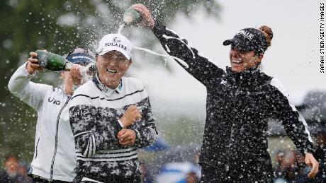 Gabby Lopez (right) and Brooke Henderson (left) pour champagne on Ko after her win at the Founders Cup at Mountain Ridge Country Club.