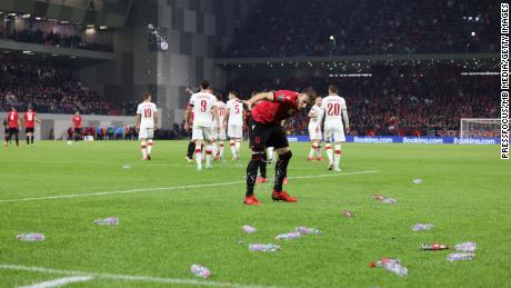 Objects are thrown onto the pitch during the World Cup qualifier between Albania and Poland.