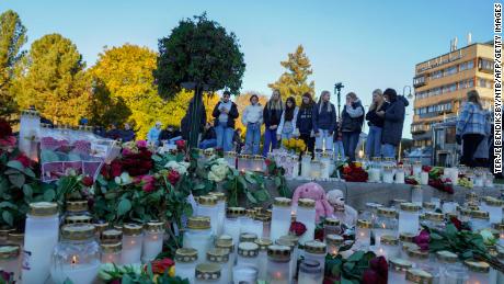 Flowers and candles are placed at a makeshift memorial for the victims of the Kongsberg attack on Stortorvet in Kongsberg, Norway, on Friday.