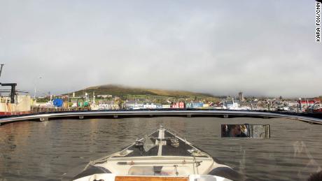 A tour boat pulls into the pier in Dingle town.