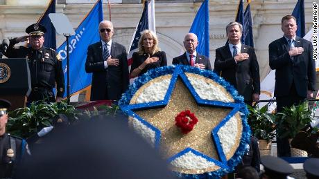 President Joe Biden accompanied by first lady Jill Biden, Secretary of Homeland Security Alejandro Mayorkas, FBI Director Christopher Wray and others listen the national anthem, during a ceremony, honoring fallen law enforcement officers at the 40th annual National Peace Officers&#39; Memorial Service at the US Capitol in Washington, Saturday, October 16, 2021. 