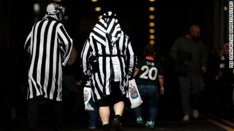 Newcastle United fans pictured wearing mock Arab clothing before the match against Tottenham.