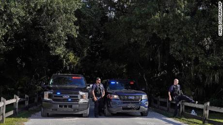 North Port police officers block the entrance to the Myakkahatchee Creek Environmental Park in North Port, Florida, on Wednesday, October 20, 2021.