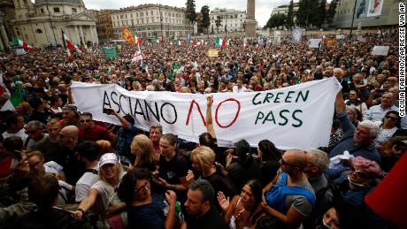 People gather in Piazza del Popolo square during a protest against the Covid-19 health pass, in Rome, Saturday, October 9, 2021. 