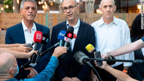 Lawyers Shmuel Moran, center, and Avi Himi, left, who represent the Italian family of Eitan Biran, speak during a press conference in Tel Aviv, Israel, Monday, October 25, 2021.