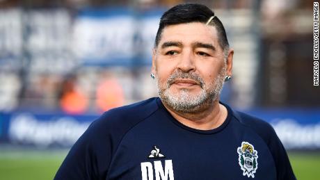 Maradona looks on before a match between Gimnasia y Esgrima La Plata and Velez.