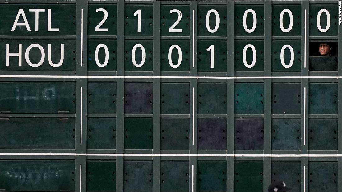 A scoreboard worker watches during the seventh inning of Game 1.