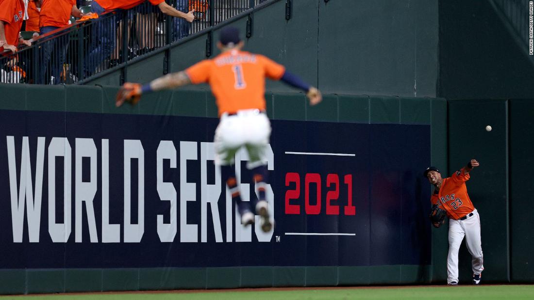 Michael Brantley of the Astros catches a fly ball against the Braves during the eighth inning of Game 2.