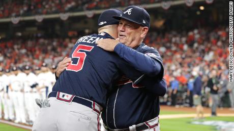 Freddie Freeman of the Atlanta Braves hugs manager Brian Snitker during Game 1 of the 2021 World Series.