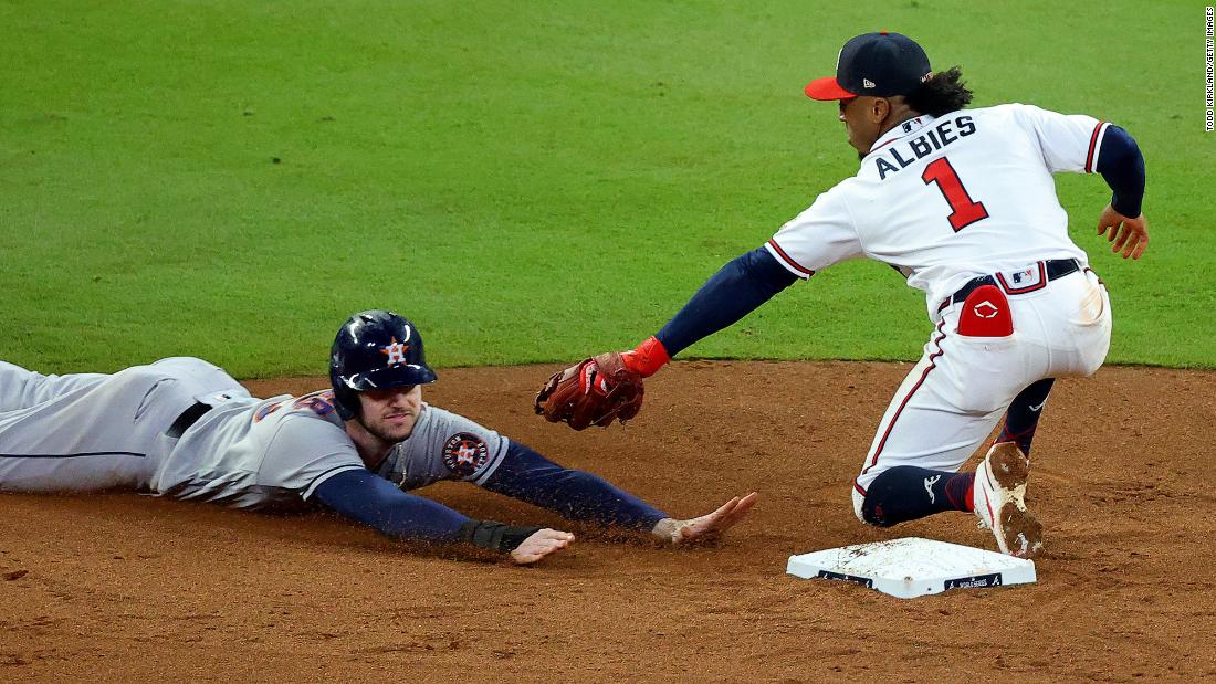 Kyle Tucker of the Astros steals second base before advancing to third as Braves second baseman Ozzie Albies misses the ball in the fifth inning.