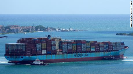 Tugboats work together to rotate the Axel Maersk container ship as it arrives in Miami. 