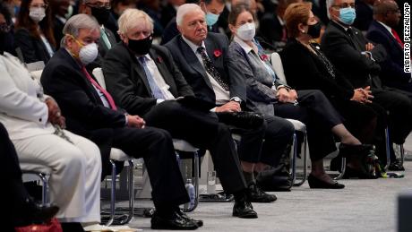 British broadcaster and naturalist David Attenborough, center, sits next to British Prime Minister Boris Johnson at the COP26 climate summit in Glasgow.