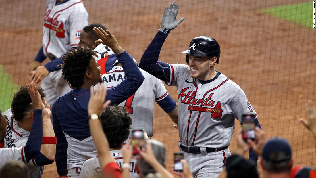 Braves first baseman Freddie Freeman celebrates with his teammates after hitting a solo home run.