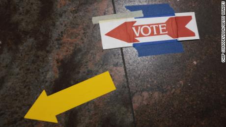  Signs taped to the floor direct voters to the polls at the Fairfax County Government Center on Nov. 2, 2021 in Fairfax, Virginia. 