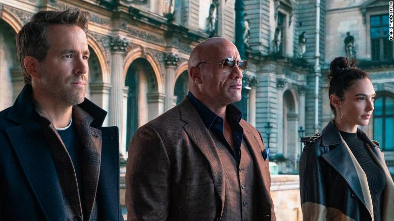 Dwayne Johnson, Ryan Reynolds and Gal Gadot go for the green in 'Red Notice'