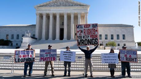 Demonstrators rally outside the US Supreme Court in Washington,  November 3, 2021. The Supreme Court was set to hear arguments in a gun-rights case that centers on  whether limits the state of New York has placed on carrying a gun in public violate the Second Amendment. 