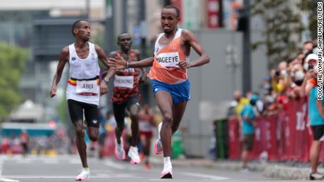 Nageeye urges Abdi towards the finish line of the Olympic marathon.  
