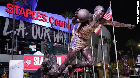 The statue of former Los Angeles Lakers Magic Johnson is seen in front of Staples Center following an NBA basketball game between the Los Angeles Clippers and the San Antonio Spurs Tuesday, Nov. 16, 2021, in Los Angeles. The Staples Center in downtown Los Angeles will be renamed Crypto.com Arena on Christmas. The home of the NBA&#39;s Lakers and Clippers, the NHL&#39;s Kings and the WNBA&#39;s Sparks will change its name after 22 years. (AP Photo/Mark J. Terrill)