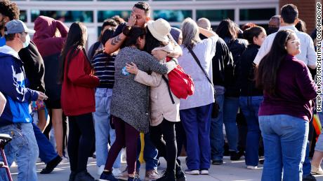 Parents reunite with their children outside of Hinkley High School in Aurora, Colorado, on November 19, 2021.