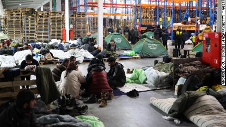 Migrants stay in the transport and logistics centre near the Bruzgi border point on the Belarusian-Polish border in the Grodno region on November 22, 2021. - Belarusian leader Alexander Lukashenko said November 22 that the European Union was refusing to discuss the fate of 2,000 migrants wishing to go to Europe and stranded in Belarus. - Belarus OUT (Photo by Andrei POKUMEIKO / BELTA / AFP) / Belarus OUT (Photo by ANDREI POKUMEIKO/BELTA/AFP via Getty Images)