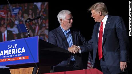 Former U.S. President Donald Trump welcomes candidate for U.S. Senate and U.S. Rep. Mo Brooks to the stage during a 