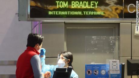 A person is tested for Covid-19 inside the Tom Bradley International Terminal at Los Angeles International Airport on December 01, 2021