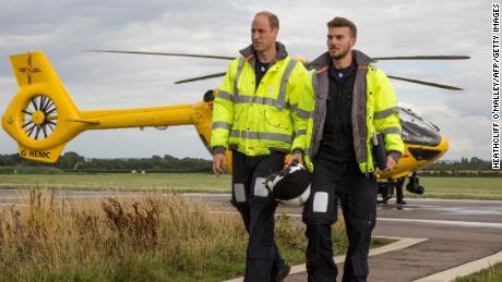 Prince William, left, arrives for his final shift working with the East Anglian Air Ambulance as a pilot at Cambridge Airport, eastern England on July 27, 2017. 