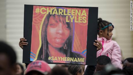 A woman holds a sign in honor of Charleena Lyles during a protest and rally in honor of Lyles on June 20, 2017, 在西雅图, 华盛顿州. 