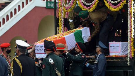 Army officers and soldiers carry the coffin containing the remains of Gen. Bipin Rawat.